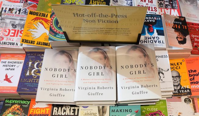 The memoir book of Virginia Giuffre, "Nobody's Girl" is seen amongst other books in a store and is up for sale in London, Tuesday, Oct. 21, 2025 six months after Giuffre died by suicide in April.(AP Photo/Kirsty Wigglesworth)