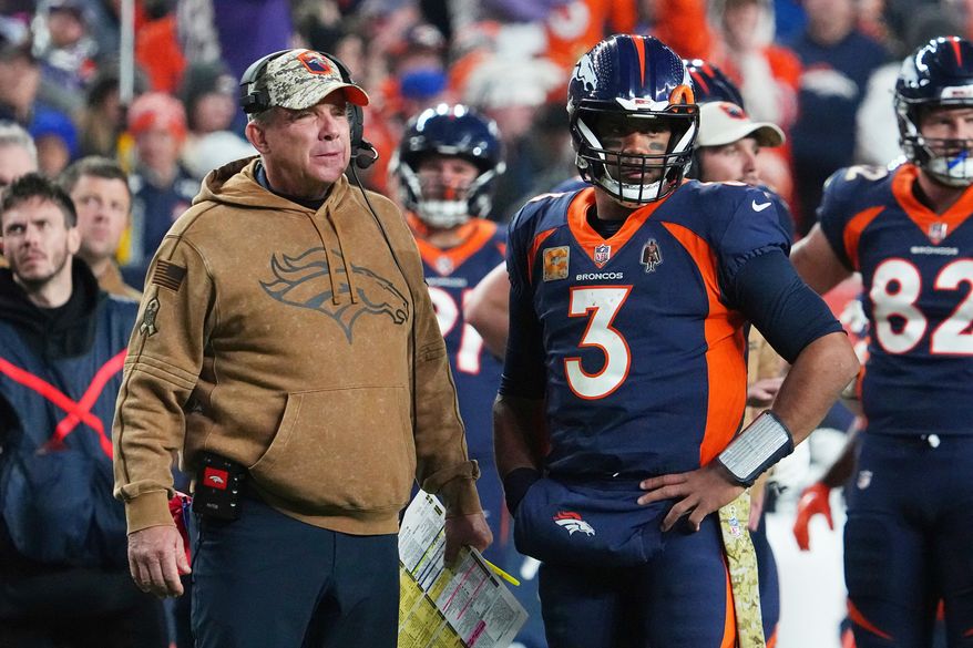 FILE - Denver Broncos head coach Sean Payton and quarterback Russell Wilson (3) look on during a timeout in an NFL football game against the Minnesota Vikings, Nov. 19, 2023, in Denver. (AP Photo/Bart Young, File)