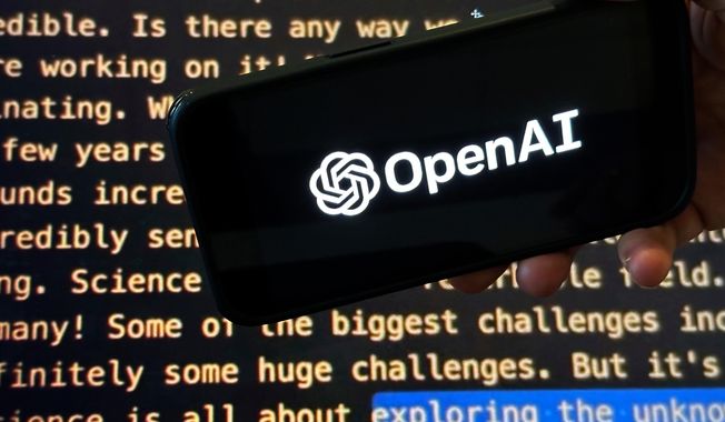 FILE - The OpenAI logo appears on a mobile phone in front of a screen showing part of the company website in this photo taken on Nov. 21, 2023 in New York. (AP Photo/Peter Morgan, File)