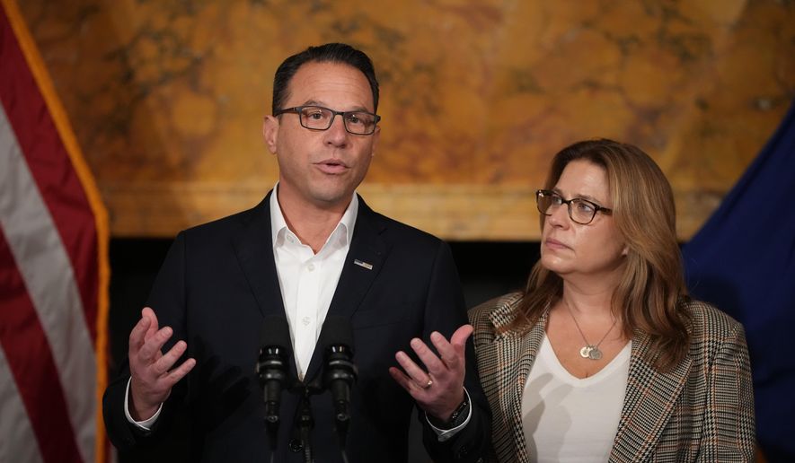 Pennsylvania Gov. Josh Shapiro, accompanied by his wife Lori Shapiro, speaks during a news conference after Cody Balmer plead guilty to attempted murder and other charges, on Tuesday, Oct. 14, 2025 in Harrisburg, Pa. (AP Photo/Matt Slocum)
