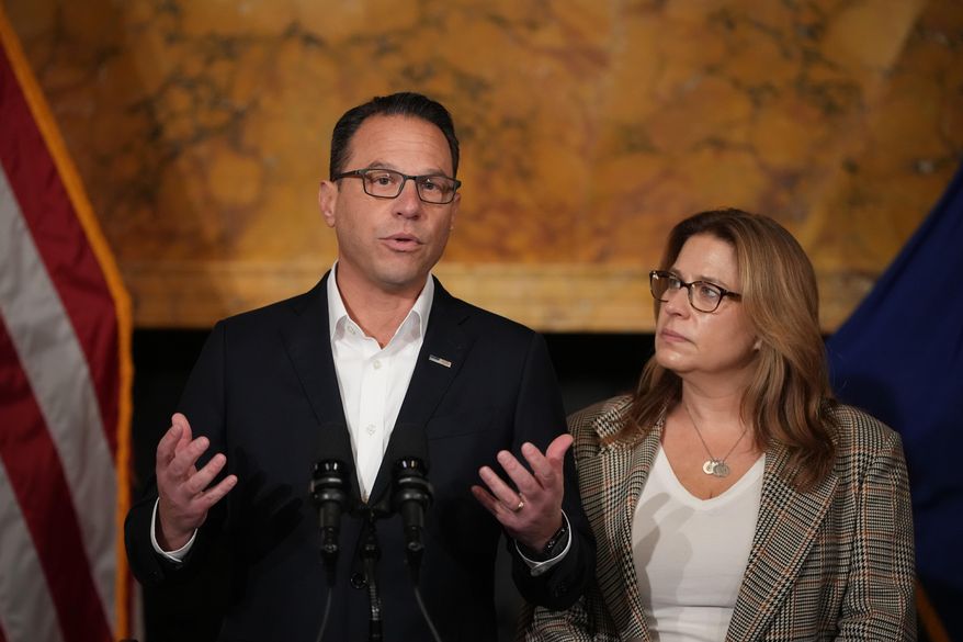 Pennsylvania Gov. Josh Shapiro, accompanied by his wife Lori Shapiro, speaks during a news conference after Cody Balmer plead guilty to attempted murder and other charges, on Tuesday, Oct. 14, 2025 in Harrisburg, Pa. (AP Photo/Matt Slocum)
