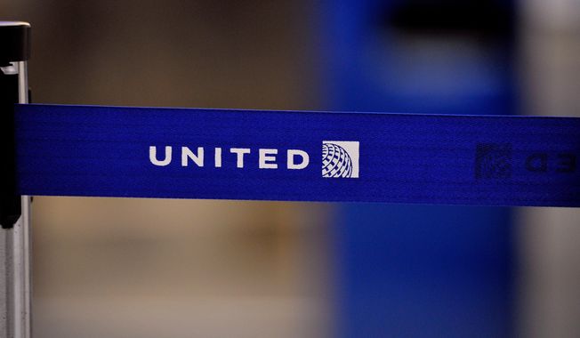 FILE - The United Airlines logo can be seen on a rope line at O'Hare International Airport, May 17, 2011. (AP Photo/Brian Kersey, File)