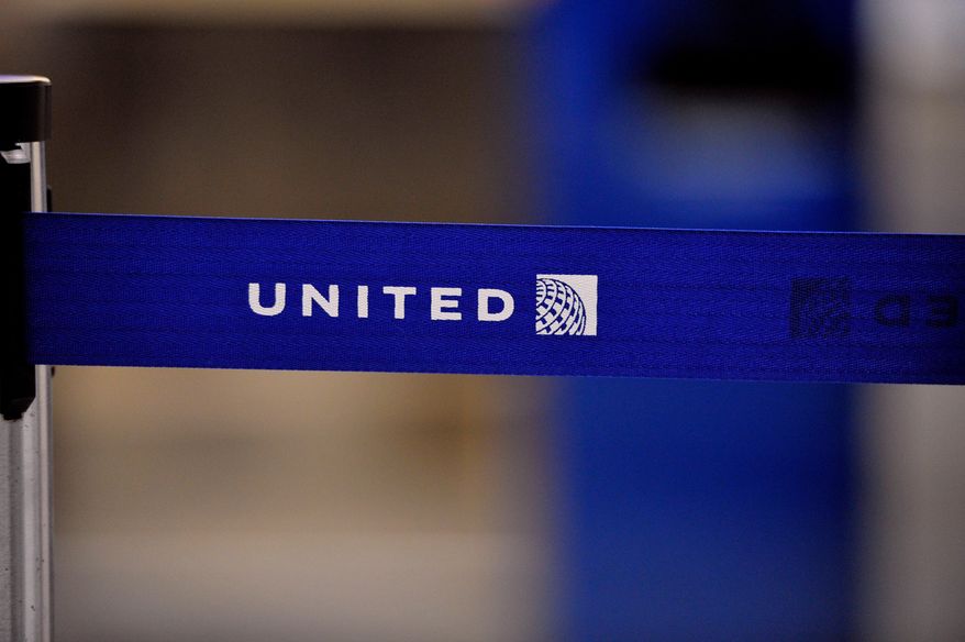 FILE - The United Airlines logo can be seen on a rope line at O'Hare International Airport, May 17, 2011. (AP Photo/Brian Kersey, File)