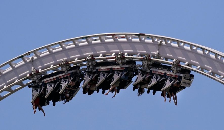 Visitors ride a roller coaster at Six Flags Magic Mountain in Valencia, Calif., April 1, 2021. (AP Photo/Jae C. Hong) **FILE**