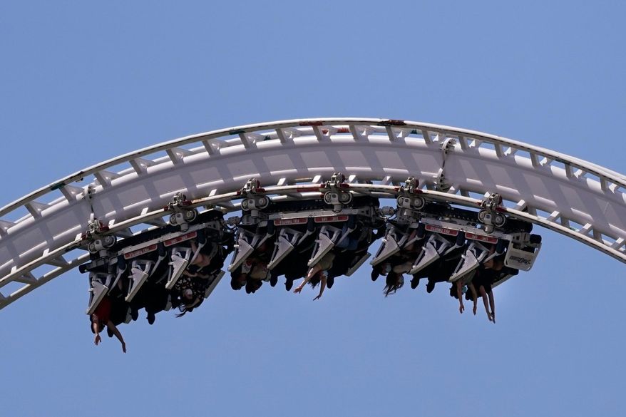 Visitors ride a roller coaster at Six Flags Magic Mountain in Valencia, Calif., April 1, 2021. (AP Photo/Jae C. Hong) **FILE**
