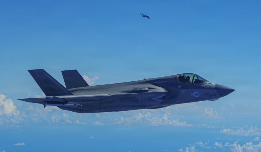 In this image provided by the U.S. Air Force, a Marine Corps F-35B Lightning II aircraft flies alongside a U.S. Air Force B-52H Stratofortress bomber in the U.S. Southern Command area of responsibility, Oct. 15, 2025. (U.S. Air Force via AP)