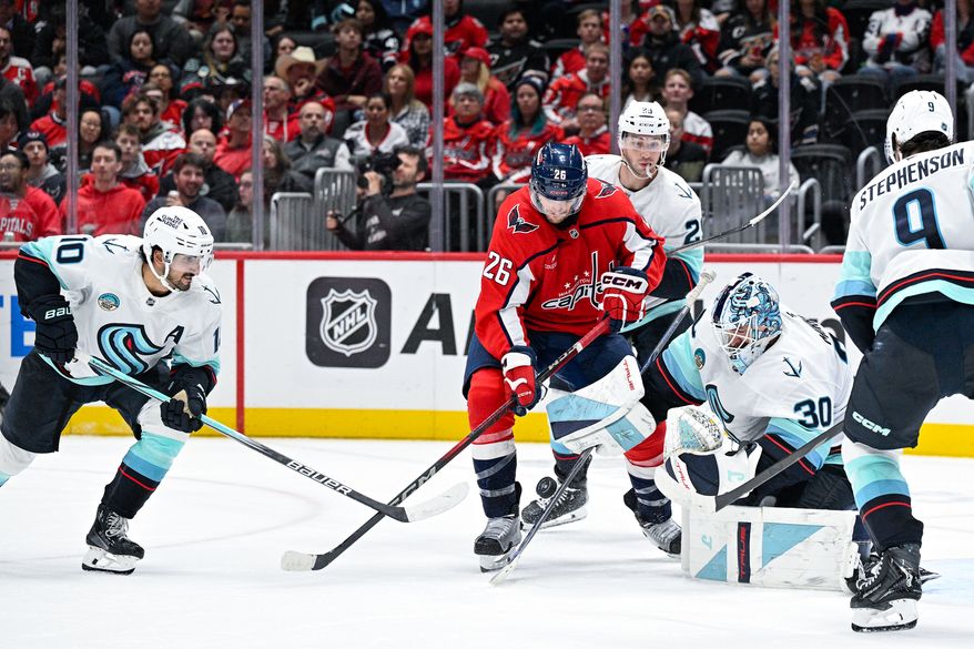 Washington Capitals center Nic Dowd (26) fights for a loose puck in front of Seattle Kraken goalie Matt Murray (30) at Capital One Arena, Washington, D.C., October 21, 2025. (Photo by Brian Murphy for the Washington Times)