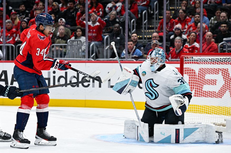 Washington Capitals right wing Justin Sourdif (34) attempts to deflect the puck on net against Seattle Kraken goalie Matt Murray (30) at Capital One Arena, Washington, D.C., October 21, 2025. (Photo by Brian Murphy for the Washington Times)