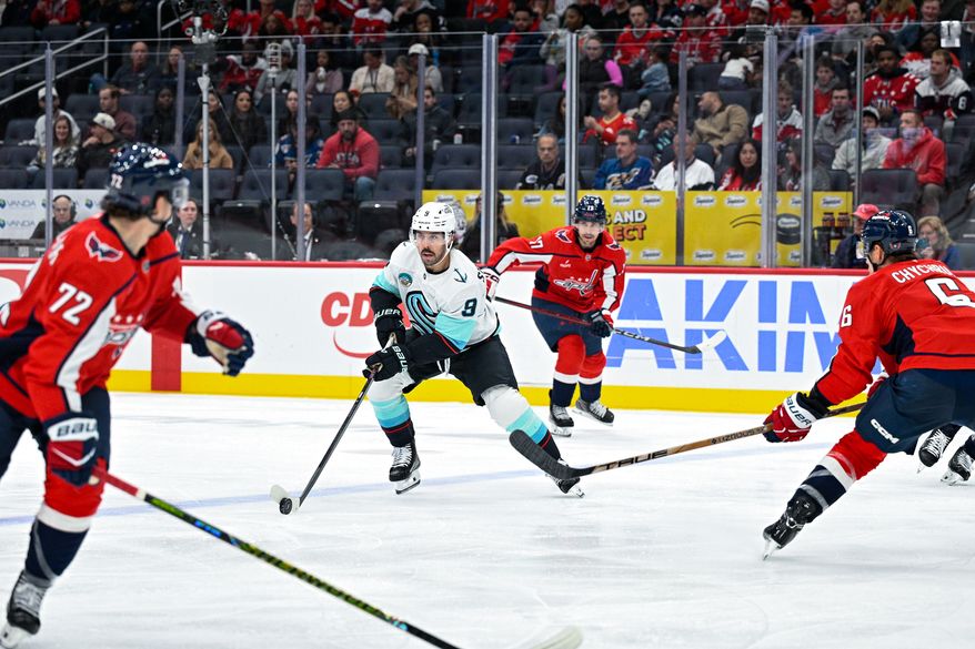 Washington Capitals defenseman Jakob Chychrun (6) closes down Seattle Kraken center Chandler Stephenson (9) in the defensive zone during the second period at Capital One Arena, Washington, D.C., October 21, 2025. (Photo by Brian Murphy for the Washington Times)