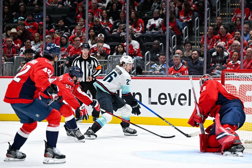 Washington Capitals defenseman Trevor van Riemsdyk (57) chases after Seattle Kraken center Ryan Winterton (26) in the defensive zone during the second period at Capital One Arena, Washington, D.C., October 21, 2025. (Photo by Brian Murphy for the Washington Times)