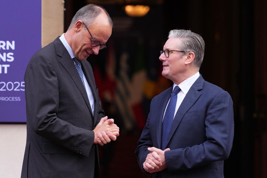 Britain's Prime Minister Keir Starmer welcomes German Chancellor Friedrich Merz to a meeting of leaders of six Western Balkan nations with British and European officials at a Western Balkans Summit in London, Wednesday, Oct. 22, 2025.(AP Photo/Kirsty Wigglesworth, Pool)
