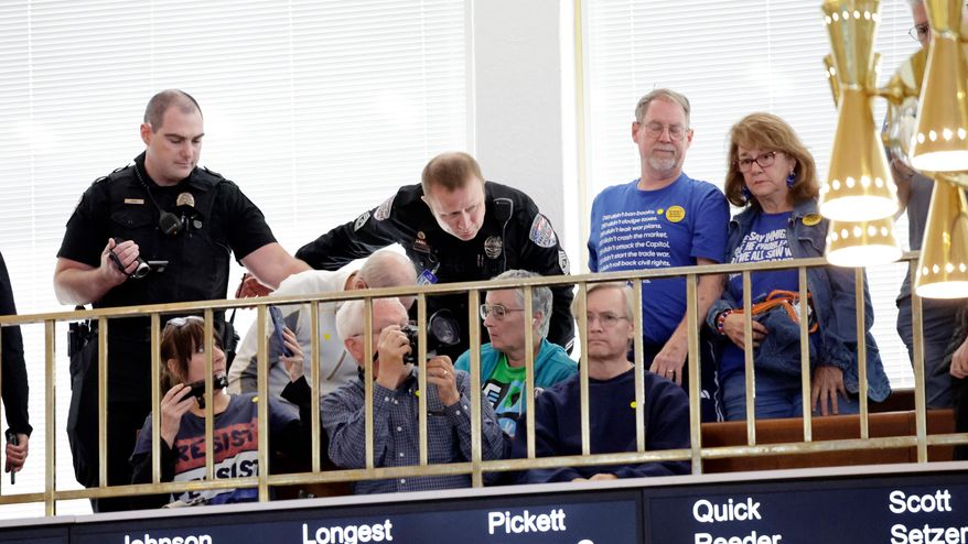 Security clears the gallery after an outburst during a redistricting bill debate at the Legislative Building, Wednesday, Oct. 22, 2025, in Raleigh, N.C. (AP Photo/Chris Seward)