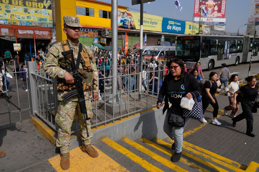 A soldier stands guard at a bus stop in Lima, Peru, Wednesday, Oct. 22, 2025, after President Jose Jeri declared a state of emergency. (AP Photo/Martin Mejia)