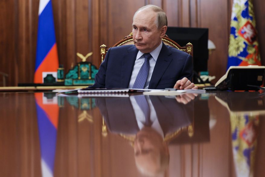 Russian President Vladimir Putin listens to the head of the Federal Service for Supervision of Natural Resources (Rosprirodnadzor) Svetlana Radionova during their meeting at the Kremlin in Moscow, Russia, on Tuesday, Oct. 21, 2025. (Alexander Kazakov, Sputnik, Kremlin Pool Photo via AP)