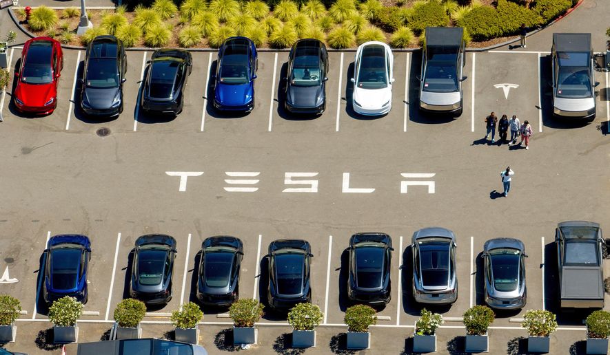 FILE - Tesla vehicles line a parking area at the company's Fremont, Calif., factory on Tuesday, Aug. 5, 2025. (AP Photo/Noah Berger, File)