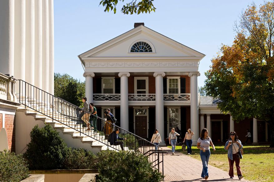 People climb steps to the Rotunda at the University of Virginia in Charlottesville, Va., Oct. 11, 2024. (AP Photo/Ryan M. Kelly, File)