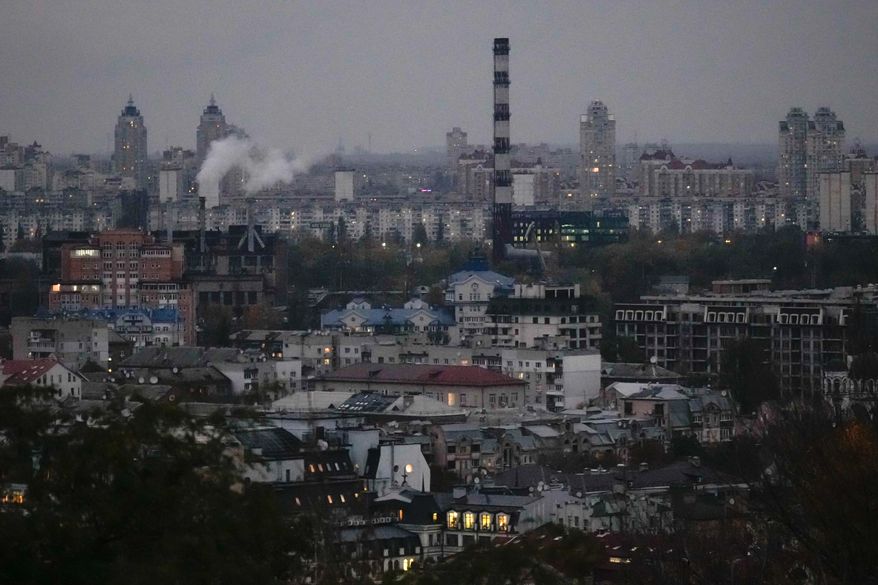 Smoke bellows in the background at dusk in Kyiv, Ukraine, Tuesday, Oct. 21, 2025. (AP Photo/Julia Demaree Nikhinson)