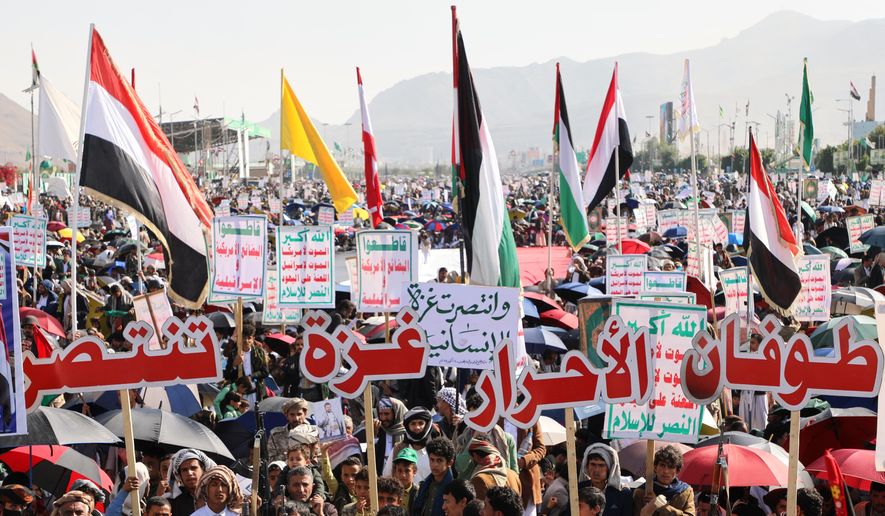 Houthi supporters celebrate following the announcement that Israel and Hamas have agreed to the first phase of a peace plan to pause the fighting, in Sanaa, Yemen, Friday, Oct. 10, 2025. Arabic reads, "Gaza victory." (AP Photo/Osamah Abdulrahman)