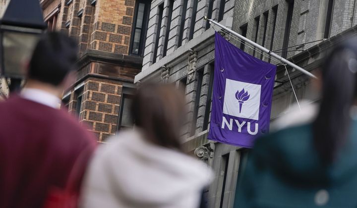 People wait in line at a COVID-19 testing site near the New York University campus, Dec. 16, 2021, in New York. (AP Photo/Seth Wenig, File)