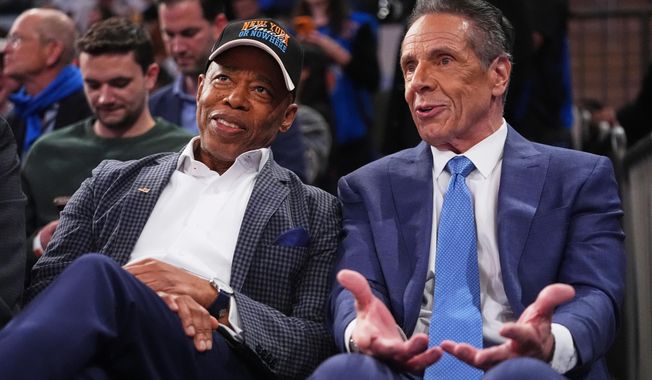 New York City Mayor Eric Adams, left, and Independent candidate former New York Gov. Andrew Cuomo, right, speak during the second half of an NBA basketball game between the New York Knicks and the Cleveland Cavaliers Wednesday, Oct. 22, 2025, at Madison Square Garden in New York. (AP Photo/Frank Franklin II)