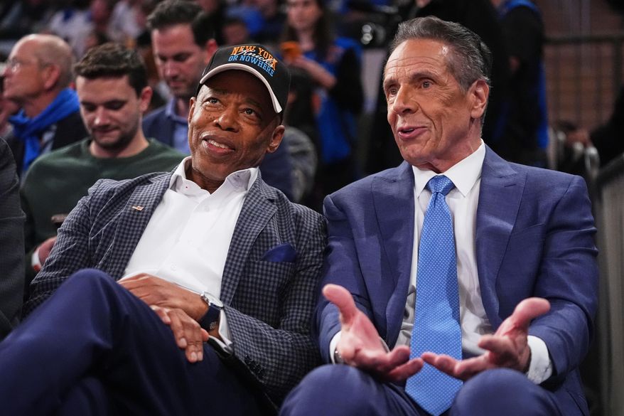New York City Mayor Eric Adams, left, and Independent candidate former New York Gov. Andrew Cuomo, right, speak during the second half of an NBA basketball game between the New York Knicks and the Cleveland Cavaliers Wednesday, Oct. 22, 2025, at Madison Square Garden in New York. (AP Photo/Frank Franklin II)