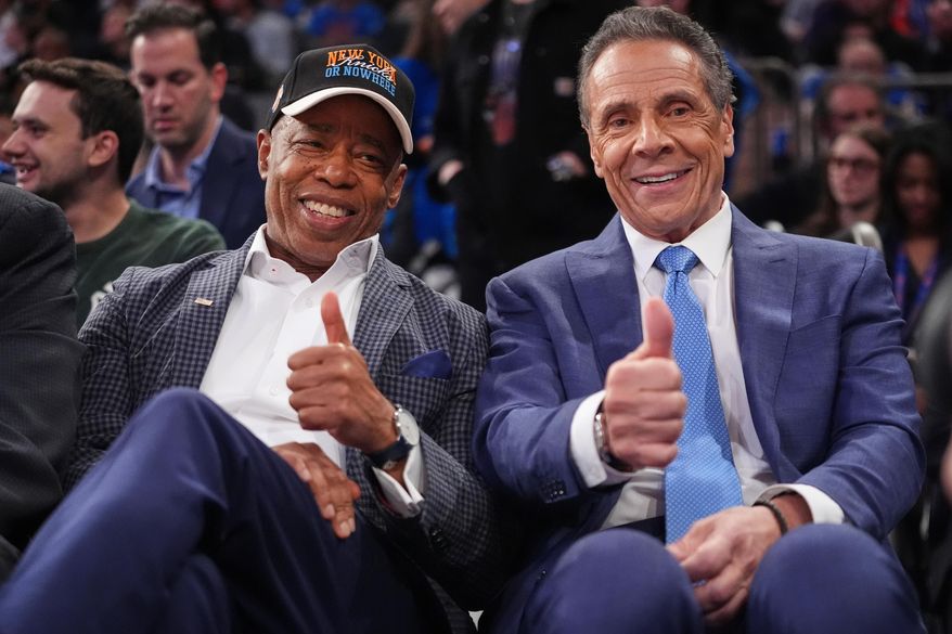 New York City Mayor Eric Adams, left, and Independent candidate former New York Gov. Andrew Cuomo, right, pose during the second half of an NBA basketball game between the New York Knicks and the Cleveland Cavaliers Wednesday, Oct. 22, 2025, at Madison Square Garden in New York. (AP Photo/Frank Franklin II)