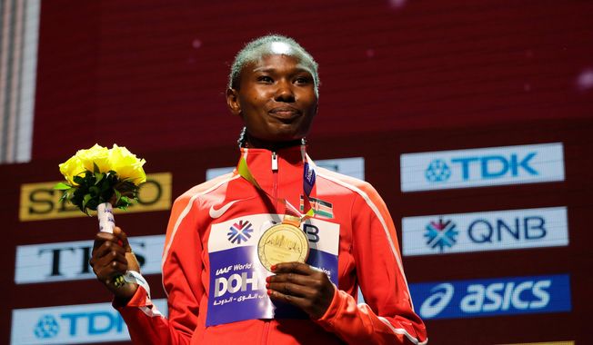 FILE - Kenya's Ruth Chepngetich poses with her gold medal during the medal ceremony for the women's marathon at the World Athletics Championships in Doha, Qatar, Sept. 28, 2019. (AP Photo/Nariman El-Mofty, file)