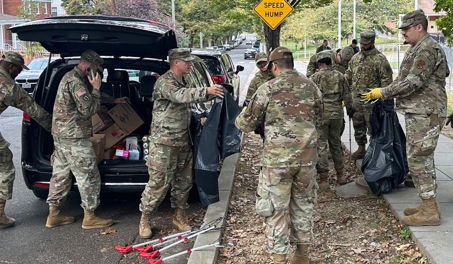 D.C. National Guard members clean up the park around Fort Stevens Recreation Center, Saturday, Oct. 11, 2025, in Washington. News of the cleanup sparked a community debate over the presence of the Guard. (AP Photo/Gary Fields)