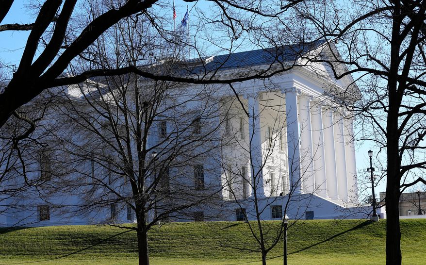 The state and U.S. flags fly over the Virginia State Capitol as the 2024 session of the Virginia General Assembly gets underway, Jan. 10, 2024, in Richmond, Va. (AP Photo/Steve Helber) **FILE**