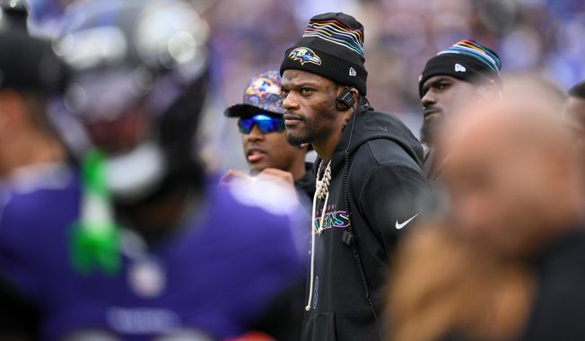 Baltimore Ravens quarterback Lamar Jackson looks on from the sidelines during the first half of an NFL football game against the Los Angeles Rams Sunday, Oct. 12, 2025, in Baltimore. (AP Photo/Nick Wass)