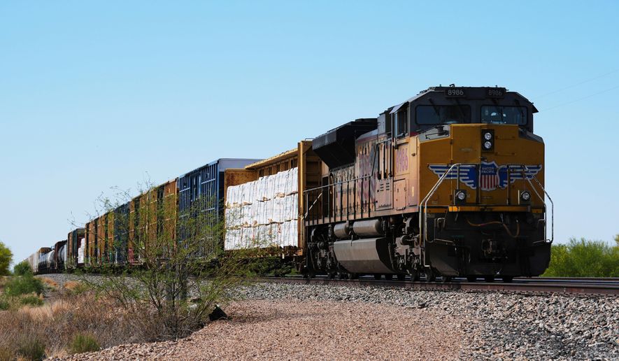FILE - A Union Pacific freight train idles on the track as it waits to continue moving, Thursday, April 17, 2025, in Red Rock, Ariz. (AP Photo/Ross D. Franklin, File)