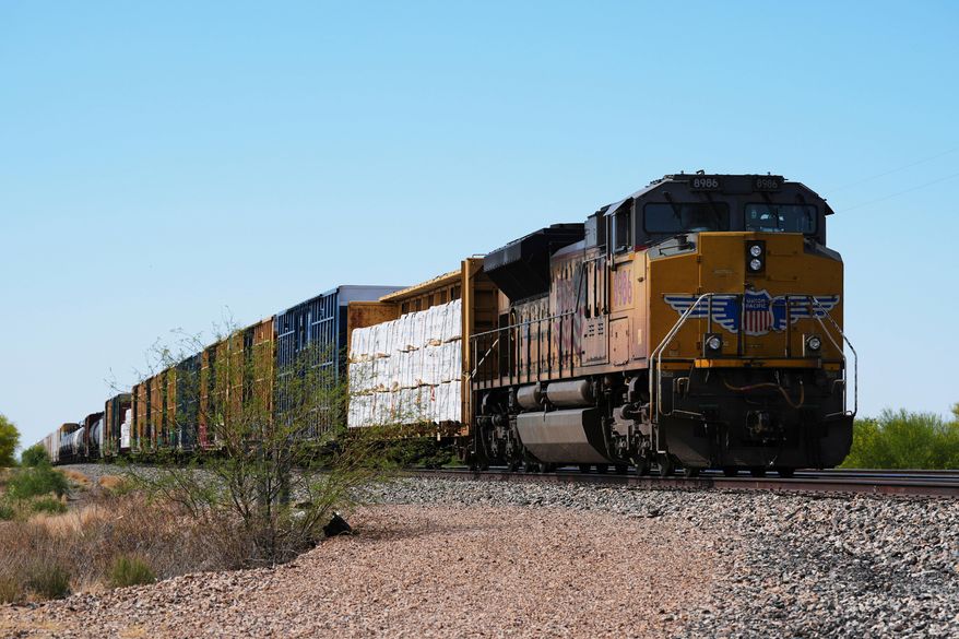 FILE - A Union Pacific freight train idles on the track as it waits to continue moving, Thursday, April 17, 2025, in Red Rock, Ariz. (AP Photo/Ross D. Franklin, File)