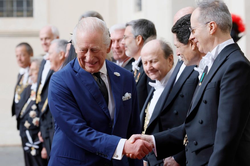 Britain's King Charles III arrives with Queen Camilla in the St. Damasus Courtyard at the Vatican for a state visit, where they will meet with Pope Leo XIV and pray with him in the Sistine Chapel, Thursday, Oct. 23, 2025. (Cecilia Fabiano/LaPresse via AP)