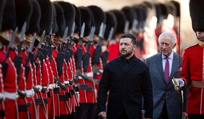Centre from left: Ukraine's President Volodymyr Zelenskyy, King Charles III and Major Ben Tracey inspecting a guard of honour at Windsor Castle, England, Friday, Oct, 24, 2025. (Aaron Chown/Pool Photo via AP)