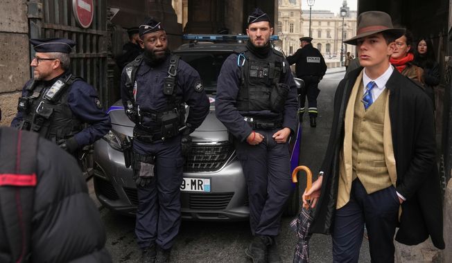Police officers block an access to the Louvre museum after a robbery Sunday, Oct. 19, 2025, in Paris. (AP Photo/Thibault Camus)