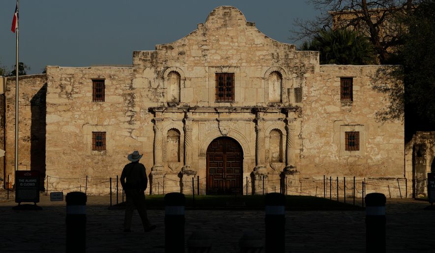 A ranger patrols the ground of the Alamo in San Antonio, Thursday, March 26, 2020. (AP Photo/Eric Gay, File)