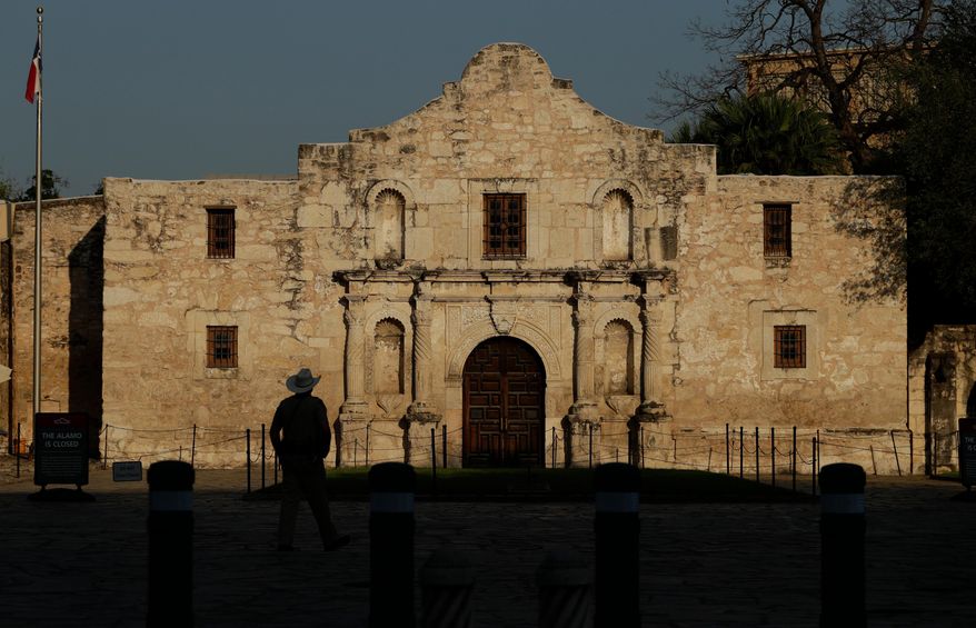 A ranger patrols the ground of the Alamo in San Antonio, Thursday, March 26, 2020. (AP Photo/Eric Gay, File)