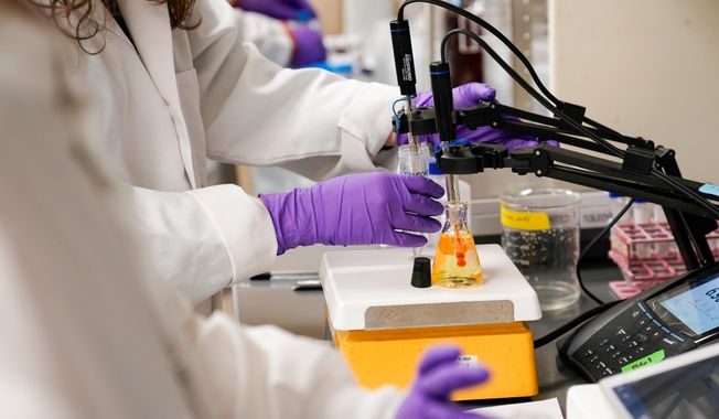 FILE - A water researcher tests a sample of water for PFAS at the U.S. Environmental Protection Agency Center For Environmental Solutions and Emergency Response in Cincinnati, on Tuesday, Feb. 14, 2023. (AP Photo/Joshua A. Bickel, File)