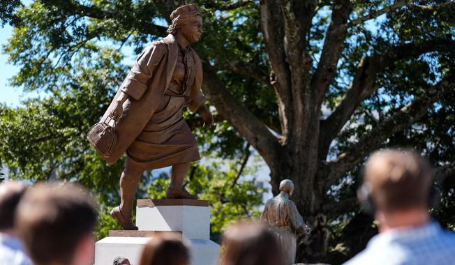 People view a newly unveiled statue of Rosa Parks on the grounds of the Alabama State Capitol, Friday, Oct. 24, 2025, in Montgomery, Ala. (AP Photo/Mike Stewart)