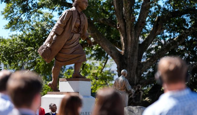 People view a newly unveiled statue of Rosa Parks on the grounds of the Alabama State Capitol, Friday, Oct. 24, 2025, in Montgomery, Ala. (AP Photo/Mike Stewart)