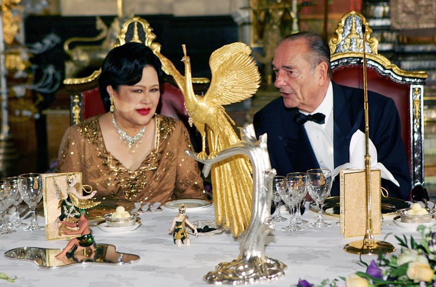 FILE - French President Jacques Chirac, right, speaks with Queen Sirikit of Thailand, at the start of a gala dinner given at the Royal Palace on the first day of his three-day official visit in Bangkok, Thailand, Friday Feb. 17, 2006. (AP Photo/Remy de la Mauviniere, Pool, File)