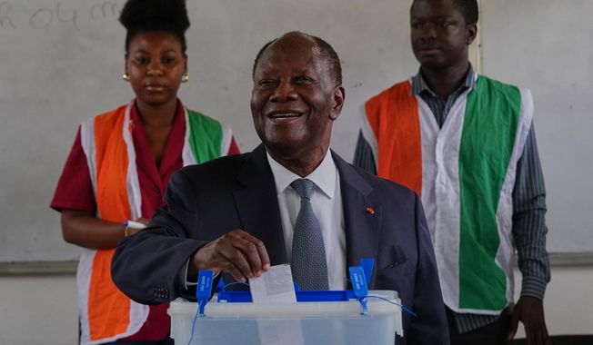 Ivory Coast President Alassane Ouattara casts his vote at a polling station during the presidential elections in Abidjan, Ivory Coast, Saturday, Oct. 25, 2025. (AP Photo/Misper Apawu)