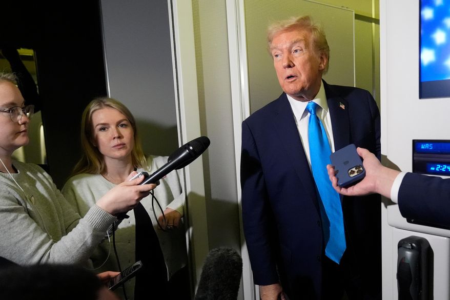 President Donald Trump speaks with reporters as White House press secretary Karoline Leavitt, second left, listens, aboard Air Force One at Al Udeid Air Base in Doha, Qatar, Saturday, Oct. 25, 2025. (AP Photo/Mark Schiefelbein)