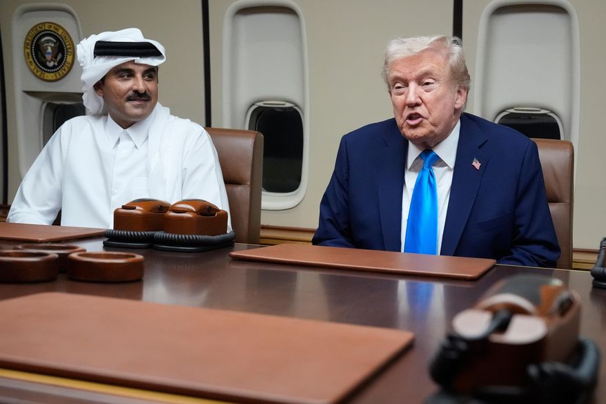 President Donald Trump, right, meets with Emir of Qatar Sheikh Tamim bin Hamad al-Thani aboard Air Force One at Al Udeid Air Base in Doha, Qatar, Saturday, Oct. 25, 2025. (AP Photo/Mark Schiefelbein)