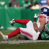 New York Giants running back Cam Skattebo (44) is injured near Philadelphia Eagles linebacker Zack Baun (53) during the first half of an NFL football game Sunday, Oct. 26, 2025, in Philadelphia. (AP Photo/Matt Slocum)