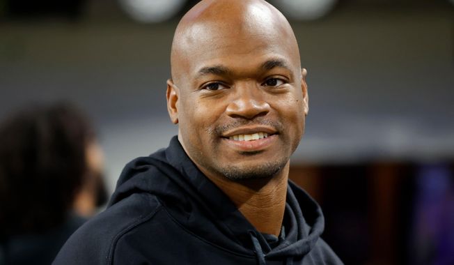 FILE - Former Minnesota Vikings running back Adrian Peterson stands on the field before an NFL football game between the Vikings and the Chicago Bears, Nov. 27, 2023, in Minneapolis. (AP Photo/Bruce Kluckhohn, File)