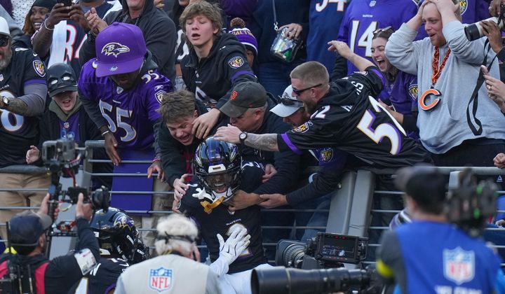 Baltimore Ravens cornerback Nate Wiggins (2) celebrates his interception with fans during the second half an NFL football game against the Chicago Bears, Sunday, Oct. 26, 2025, in Baltimore. (AP Photo/Stephanie Scarbrough)