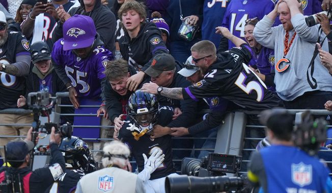 Baltimore Ravens cornerback Nate Wiggins (2) celebrates his interception with fans during the second half an NFL football game against the Chicago Bears, Sunday, Oct. 26, 2025, in Baltimore. (AP Photo/Stephanie Scarbrough)