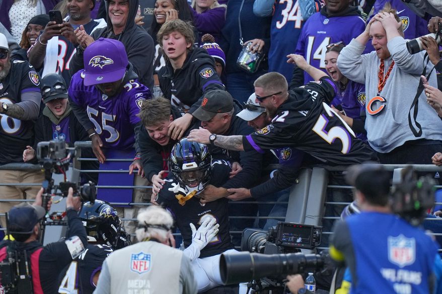 Baltimore Ravens cornerback Nate Wiggins (2) celebrates his interception with fans during the second half an NFL football game against the Chicago Bears, Sunday, Oct. 26, 2025, in Baltimore. (AP Photo/Stephanie Scarbrough)