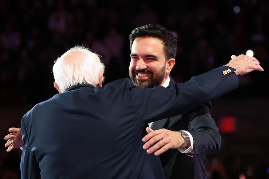 New York City mayoral candidate Zohran Mamdani, right, hugs Sen. Bernie Sanders, I-Vt., before speaking during a rally, Sunday, Oct. 26, 2025, in New York. (AP Photo/Heather Khalifa)